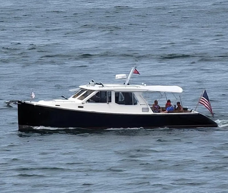 Slide: The Image of 2005 True North 38 Heritage boat cruising on open water with passengers. - 6
