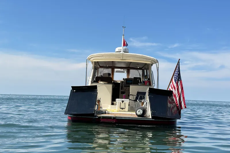 Slide: The Image of True North 38 Heritage 2005 boat on calm sea with American flag. - 7