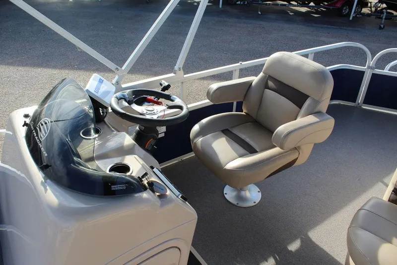 Slide: The Image of 2017 Tracker PARTY BARGE® 22 DLX boat interior with captain's chair and steering console. - 13