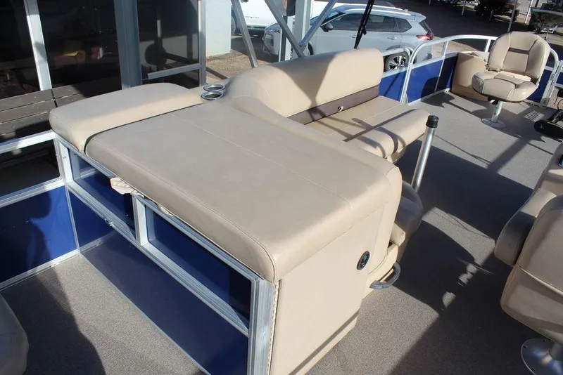 Slide: The Image of 2017 Tracker PARTY BARGE® 22 DLX pontoon boat with beige seating and blue accents. - 15