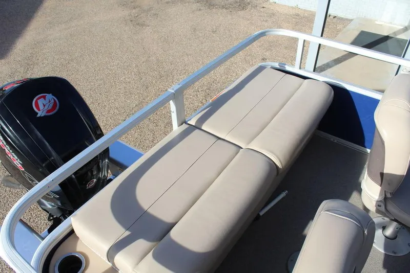 Slide: The Image of 2017 Tracker PARTY BARGE® 22 DLX pontoon boat with beige seating and outboard motor. - 16