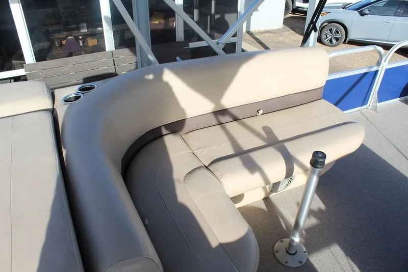 Slide: The Image of 2017 Tracker PARTY BARGE® 22 DLX pontoon boat with beige seating and cup holders. - 17