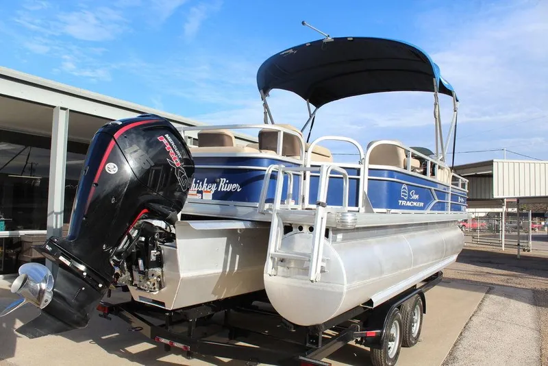 Slide: The Image of 2017 Tracker PARTY BARGE® 22 DLX pontoon boat on trailer with canopy and outboard motor. - 5