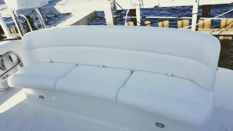 Slide: The Image of White seating on 1999 Tiara Yachts 3500 Express, docked by water. - 26