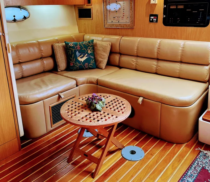 Slide: The Image of Luxurious 1999 Tiara Yachts 3500 Express interior with leather seating and wooden table. - 6