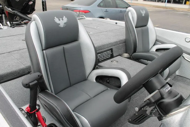 Slide: The Image of 2025 Phoenix 921 Elite II boat interior with gray seats and steering wheel. - 10