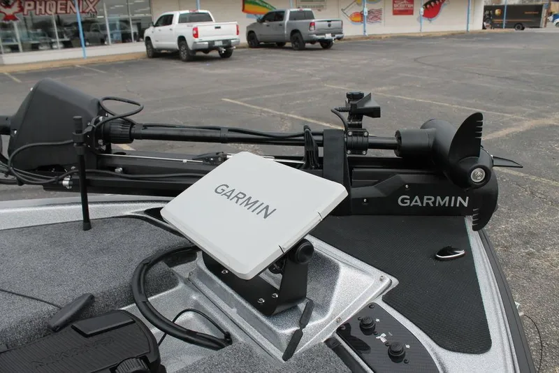 Slide: The Image of Garmin navigation system on 2025 Phoenix 921 Elite II boat, parked in a lot. - 11