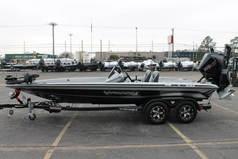 Slide: The Image of 2025 Phoenix 921 Elite II boat on trailer, parked in a lot. - 5