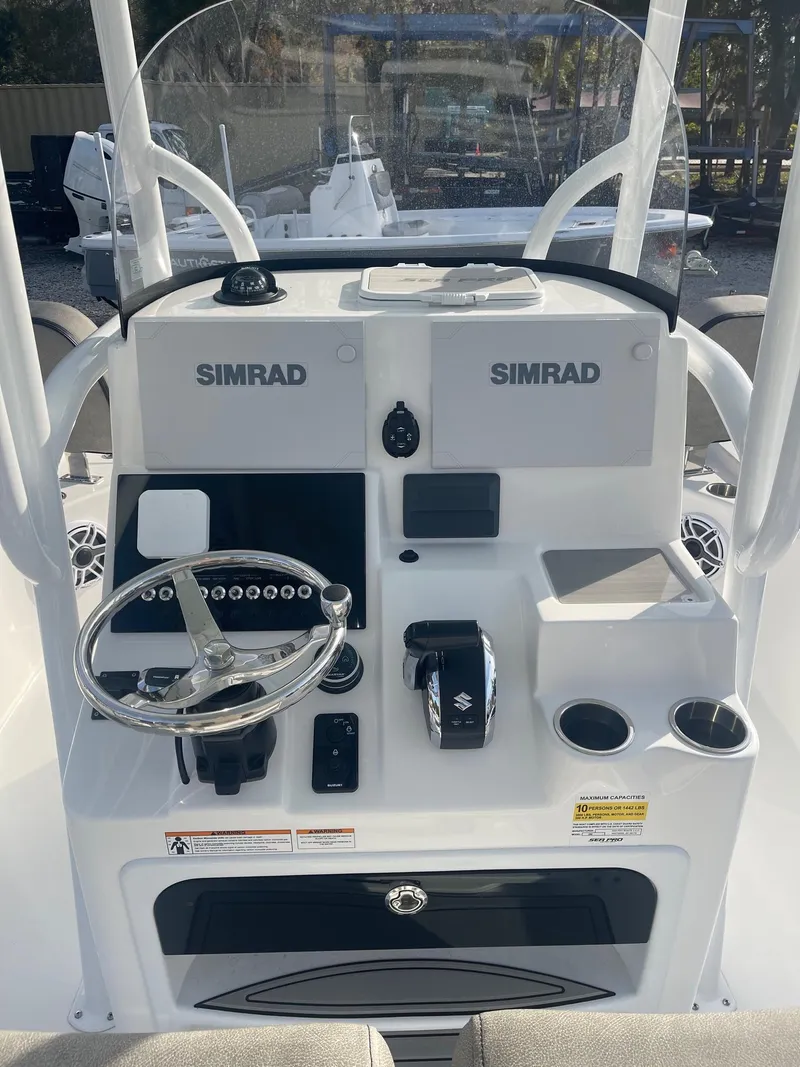 Slide: The Image of 2025 Sea Pro 250 Bay boat console with Simrad electronics and steering wheel. - 6
