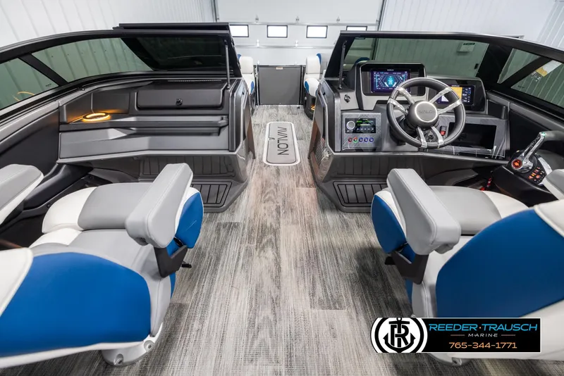 Slide: The Image of Interior of 2025 Avalon Excalibur LTD QLW boat with modern dashboard and seating. - 17