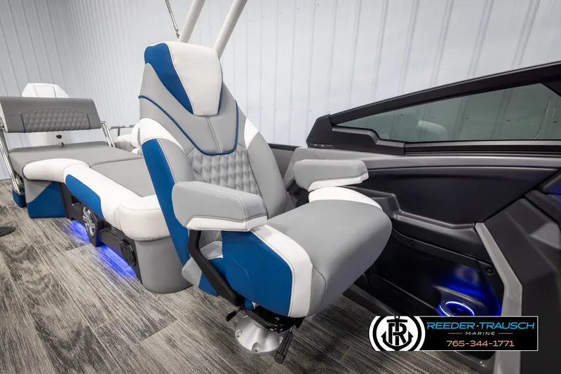 Slide: The Image of Luxurious interior of 2025 Avalon Excalibur LTD QLW boat with blue and gray seating. - 21