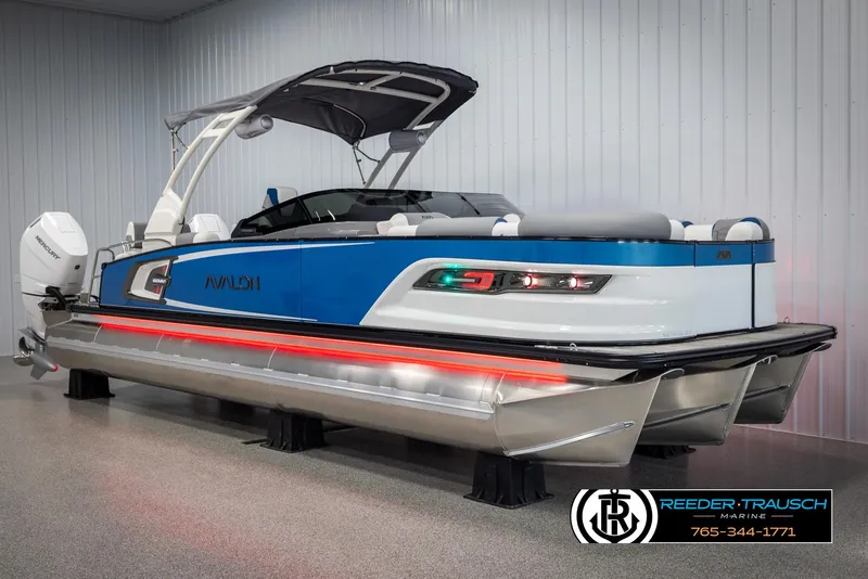 Slide: The Image of 2025 Avalon Excalibur LTD QLW pontoon boat in showroom, featuring sleek design and modern amenities. - 3