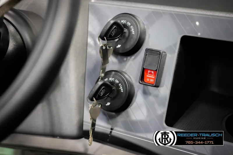 Slide: The Image of 2025 Avalon Excalibur LTD QLW dashboard with ignition keys and control switches. - 32