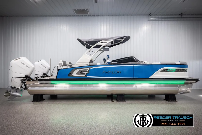 Slide: The Image of 2025 Avalon Excalibur LTD QLW pontoon boat with dual engines in a showroom. - 5