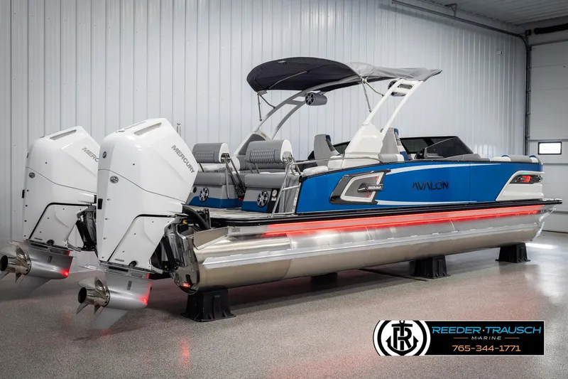 Slide: The Image of 2025 Avalon Excalibur LTD QLW pontoon boat with dual engines in a showroom. - 6