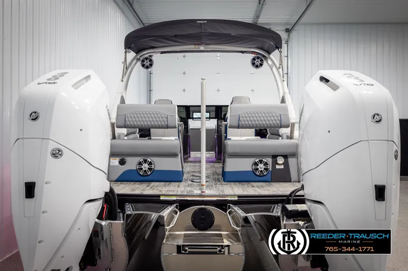 Slide: The Image of 2025 Avalon Excalibur LTD QLW boat with dual engines in a showroom. - 7