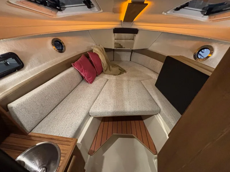 Slide: The Image of 2025 Ranger Tugs R-23 cabin interior with cozy seating and modern design. - 4