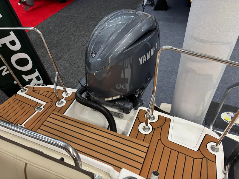 Slide: The Image of 2025 Ranger Tugs R-23 boat with Yamaha outboard motor on wooden deck. - 9