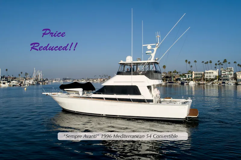 The Image of 1996 Mediterranean Convertible yacht on calm water, price reduced, coastal background. - 0