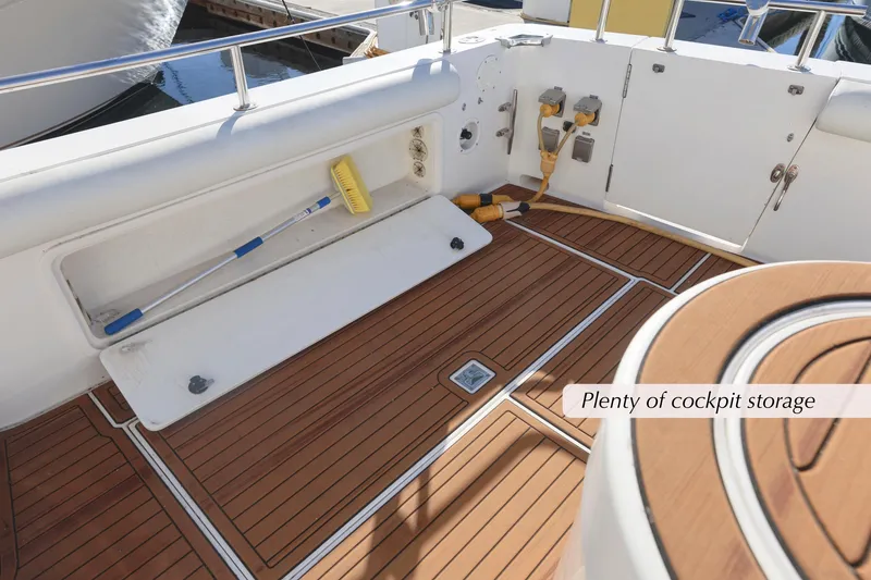 Slide: The Image of 1996 Mediterranean convertible boat cockpit with ample storage and wooden flooring. - 11