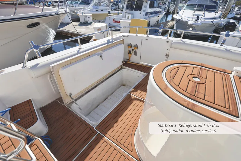 Slide: The Image of 1996 Mediterranean convertible boat with open starboard refrigerated fish box on teak deck. - 12