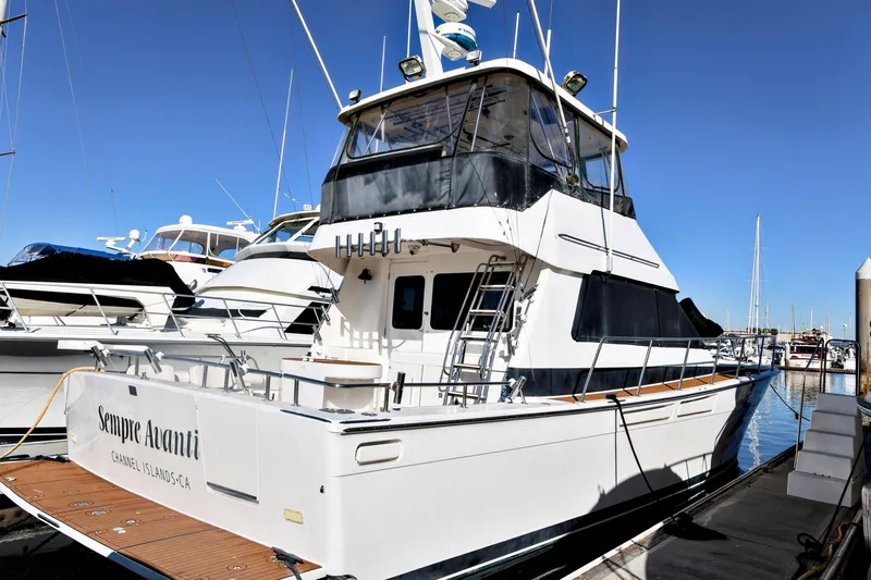 Slide: The Image of 1996 Mediterranean convertible yacht docked at a marina under clear blue skies. - 2