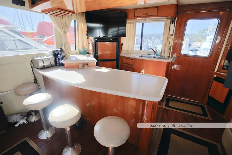 Slide: The Image of Luxurious yacht interior with bar stools, countertop, and window view. - 23