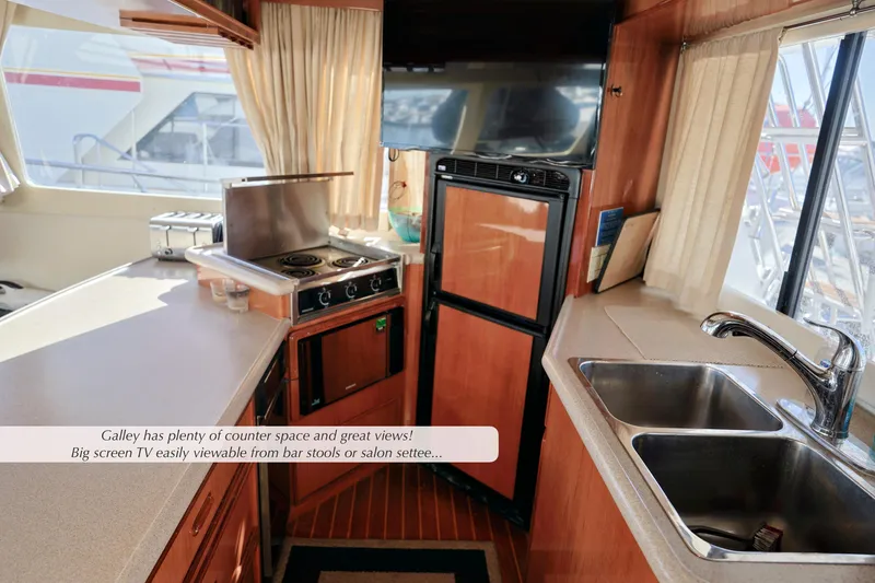 Slide: The Image of Interior of a 1996 Mediterranean convertible yacht with spacious galley and modern amenities. - 24