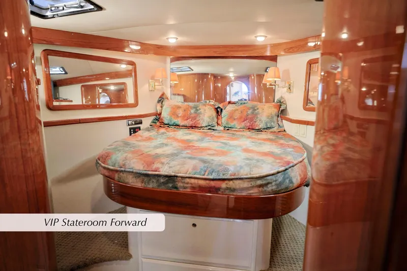 Slide: The Image of 1996 Mediterranean convertible yacht VIP stateroom with plush bedding and elegant wood accents. - 30