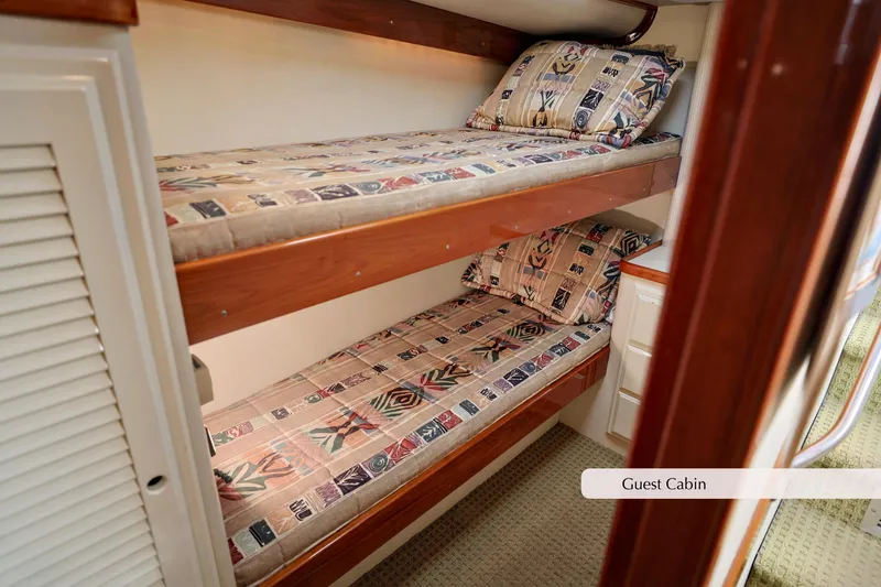 Slide: The Image of 1996 Mediterranean convertible guest cabin with bunk beds and patterned bedding. - 31