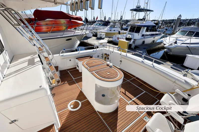 Slide: The Image of 1996 Mediterranean convertible yacht with spacious cockpit and wooden deck, docked at marina. - 6