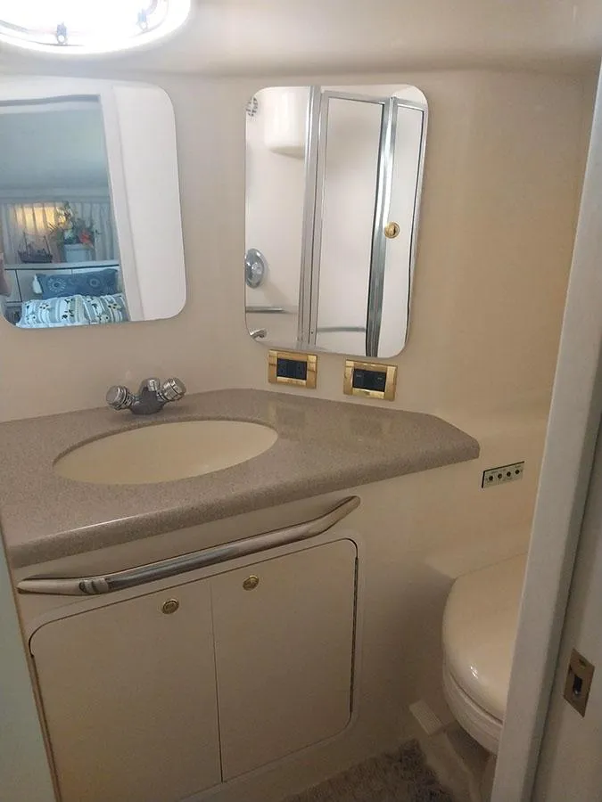Slide: The Image of 1997 Sea Ray 370 Aft Cabin bathroom with sink, mirror, and storage. - 12