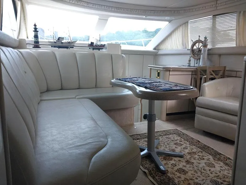 Slide: The Image of 1997 Sea Ray 370 Aft Cabin interior with plush seating and nautical decor. - 14