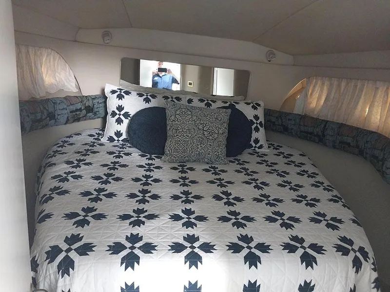 Slide: The Image of Cozy bedroom in 1997 Sea Ray 370 Aft Cabin with patterned bedding and decorative pillows. - 18