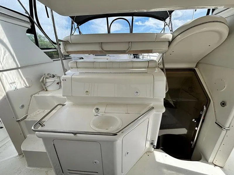 Slide: The Image of 1997 Sea Ray 370 Aft Cabin yacht interior with sink and seating area. - 22