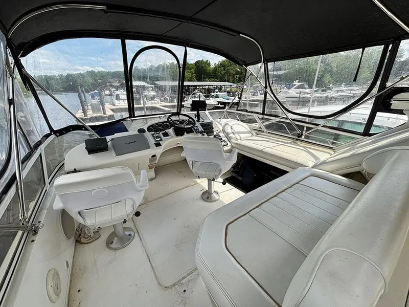 Slide: The Image of 1997 Sea Ray 370 Aft Cabin yacht interior with helm, seating, and marina view. - 23