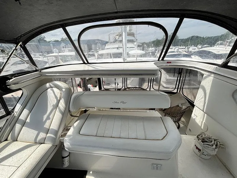 Slide: The Image of 1997 Sea Ray 370 Aft Cabin interior with white seating and panoramic windows. - 24