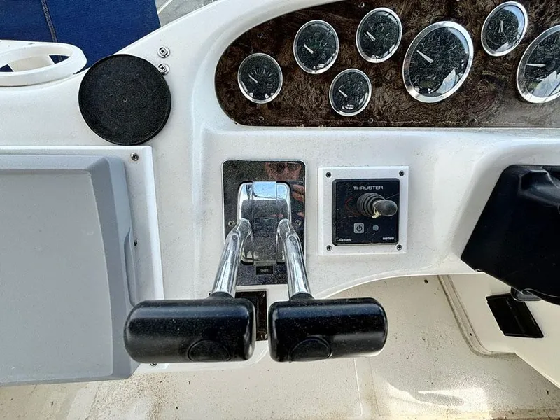 Slide: The Image of 1997 Sea Ray 370 Aft Cabin dashboard with throttle controls and instrument panel. - 28