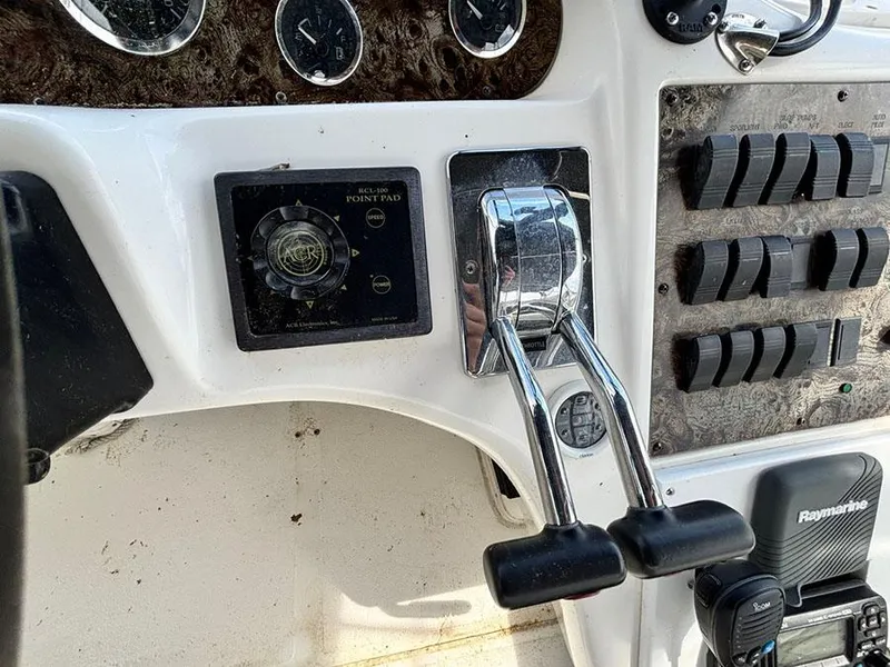 Slide: The Image of 1997 Sea Ray 370 Aft Cabin helm controls with dual throttle levers and instrument panel. - 30