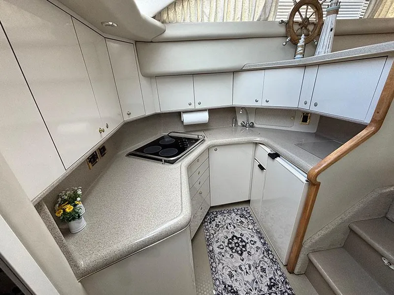 Slide: The Image of 1997 Sea Ray 370 Aft Cabin kitchen with modern appliances and elegant cabinetry. - 35