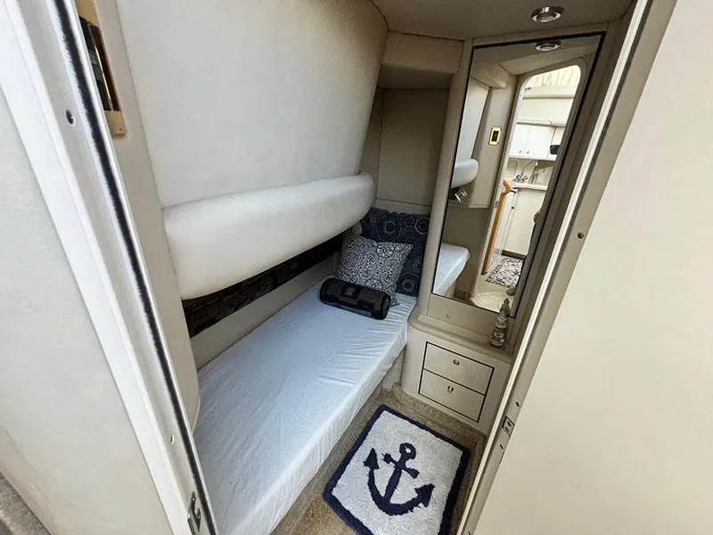 Slide: The Image of 1997 Sea Ray 370 Aft Cabin interior with bed, mirror, and nautical-themed decor. - 39