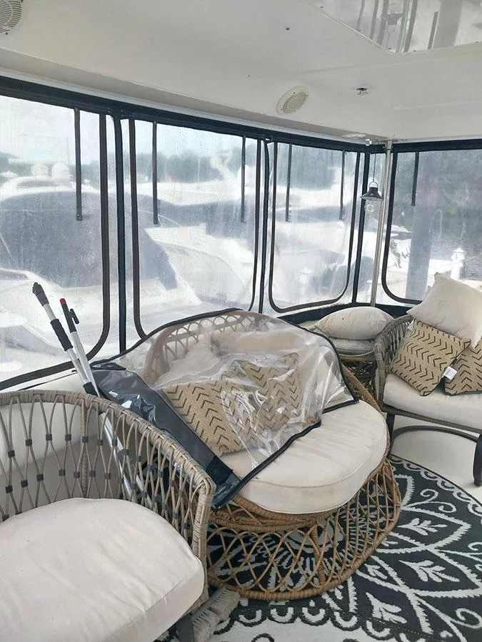Slide: The Image of 1997 Sea Ray 370 Aft Cabin interior with wicker furniture and patterned rug. - 7