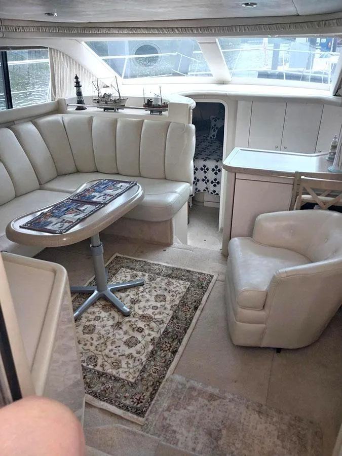 Slide: The Image of Luxurious interior of 1997 Sea Ray 370 Aft Cabin yacht with plush seating and elegant decor. - 8