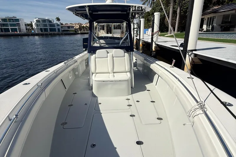 Slide: The Image of 2018 Bluewater Center Console boat docked by waterfront homes. - 10