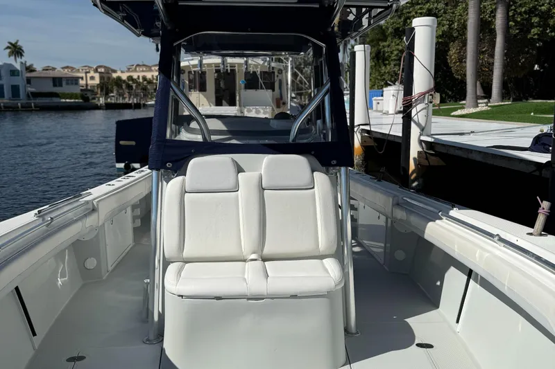 Slide: The Image of 2018 Bluewater Center Console boat docked by waterfront homes. - 12