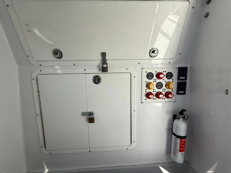 Slide: The Image of 2018 Bluewater Center Console control panel with storage and fire extinguisher. - 14