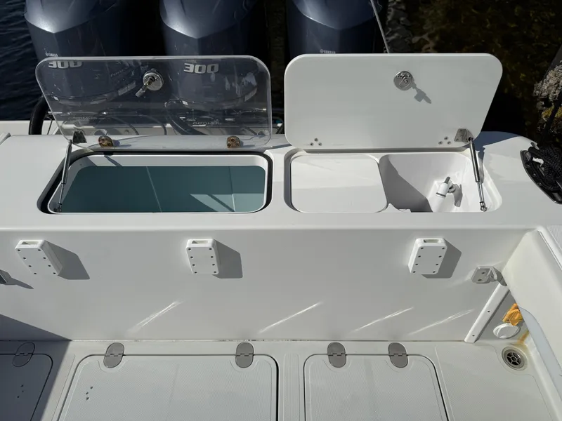 Slide: The Image of 2018 Bluewater Center Console boat with open storage compartments and visible outboard engines. - 9