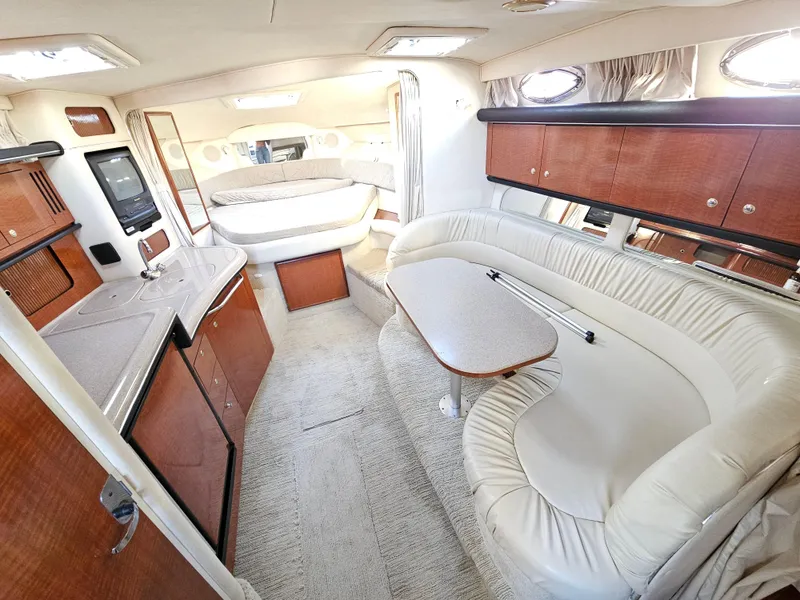 Slide: The Image of 2003 Sea Ray 340 Sundancer interior with kitchen, seating, and sleeping area. - 5