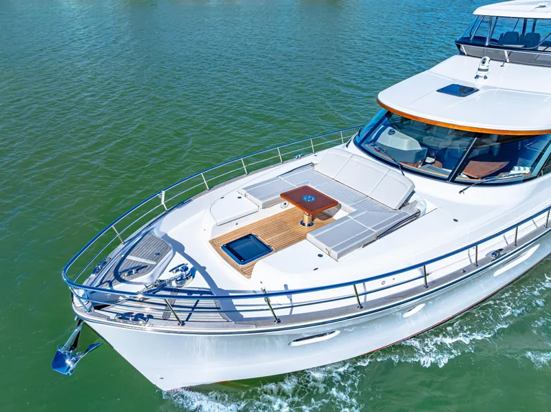 Slide: The Image of 2025 Belize 66 Daybridge yacht cruising on clear waters, showcasing sleek design and luxury features. - 13