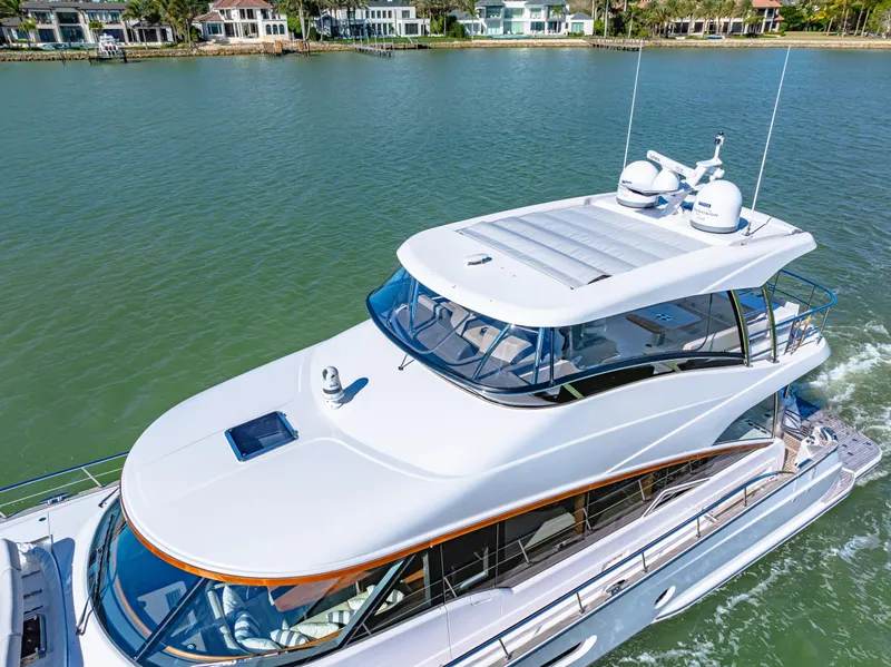 Slide: The Image of 2025 Belize 66 Daybridge luxury yacht cruising on a serene waterway. - 16